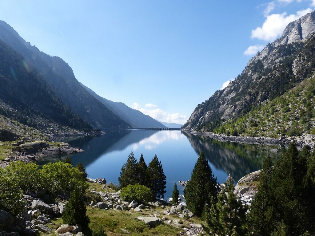 A lake in the The National Park of Aigüestortes surrounded by mountains in Spain in autumn